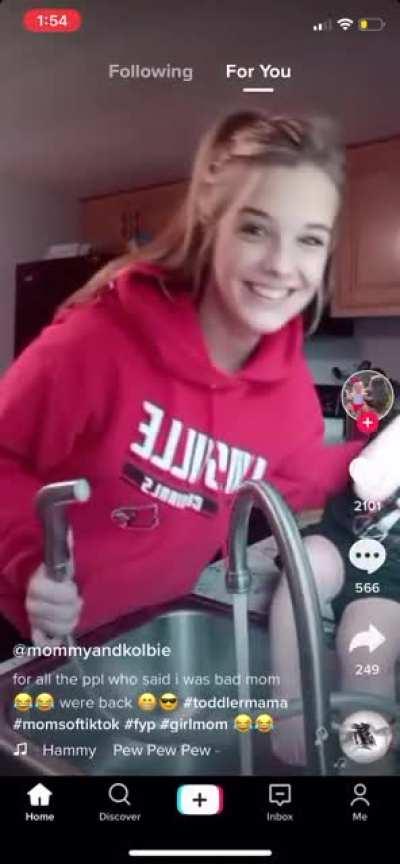 Way too young mother thinks spraying daughter in the face is hilarious, and has done it more than once per the caption.