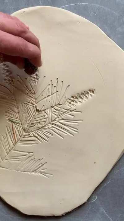 Thriving throughout cold winters, evergreen trees are a beautiful symbol of standing strong even in dark and difficult times. This piece is kiln fired ceramic painted with stains, underglaze and glaze. 22kt gold accents are added in a subsequent kiln firi