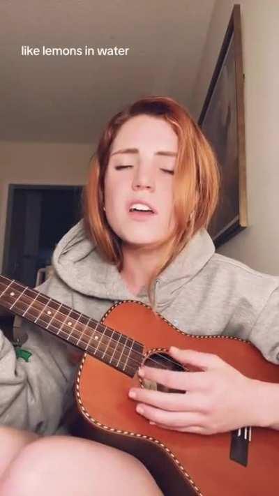 Back home playing the guitar in her Echosmith hoodie (June 2023)