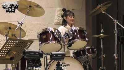Aoi Koga showing off her drumming skills to Masayoshi Oishi and Shugo Nakamura