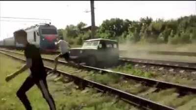 Car stuck on train tracks is destroyed