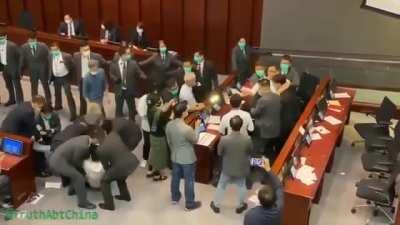 Hong Kong security forcibly removes Democratic council and then unanimously votes pro-Communist as new chairman.