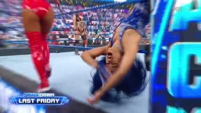 Sasha groans as Carmella knocks her out
