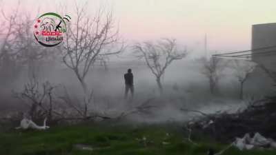 FSA fighter sprints out with an RPG to attack an SAA tank at Menagh Air Base - Aleppo - 12/29/2012