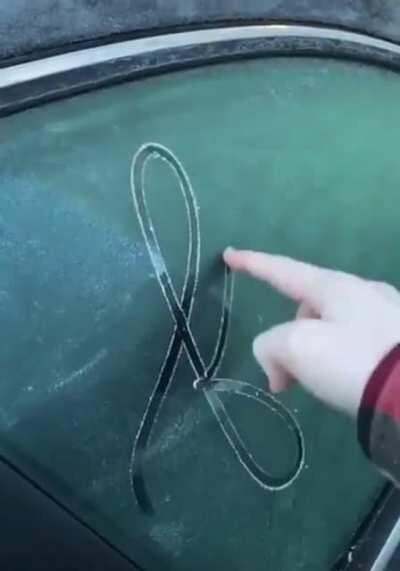 This penmanship on the ice of a car window
