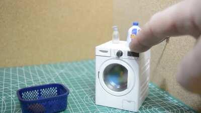 A working 3D printed washing machine for his wife's dullhouse