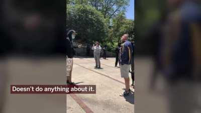 Retired Cook County judge, Robert Bertucci, takes a swing at a protester in Chicago.