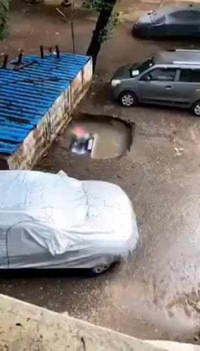 Car swallowed by sinkhole in Mumbai, India on 13th June 2021.