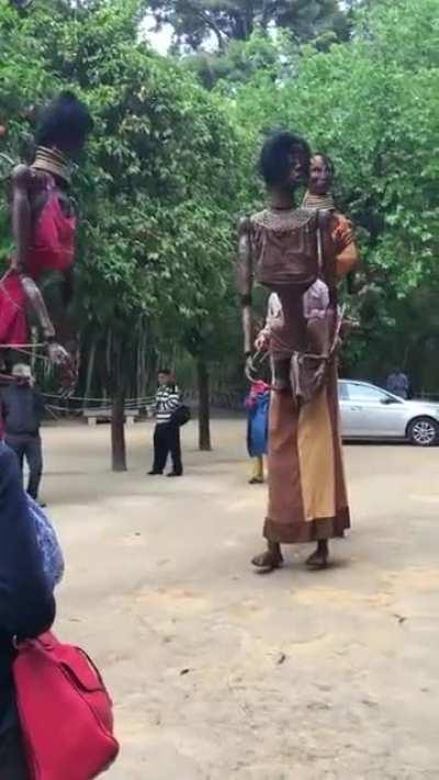 These African puppets controlled by the puppeteer on stilts.