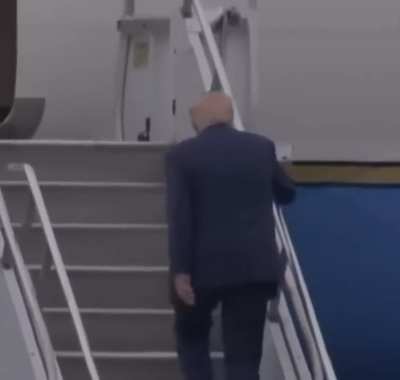 Donald Trump trips on Air Force One stairs.
