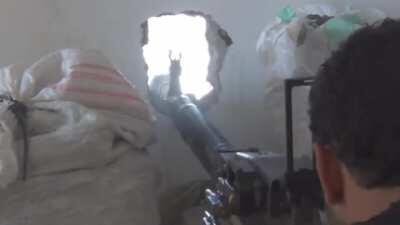 Syrian Rebels use a peephole mounted DShK machine gun to harass a sandbagged SAA window postion - 2013