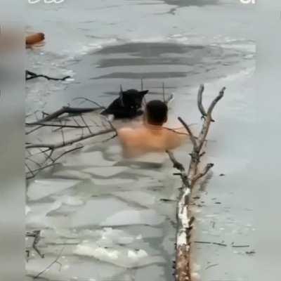 A man ventures out on cracking ice to rescue a dog trapped in the frigid water