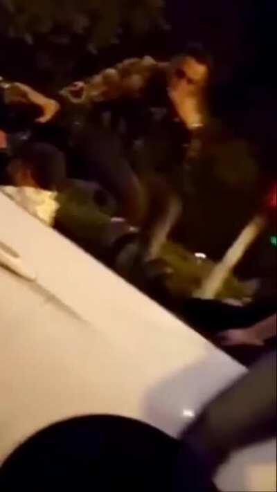 Man eats the street after riding on a car.