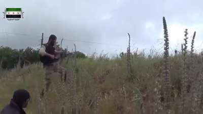 Syria Southern Front rebels near Qahtaniyah, Quneitra area. Looks like one guy is hip firing a heavy machine gun. May 2014.