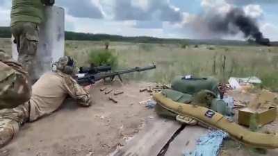 Sniper from a Special Operations Service is practicing his aim by using a Ukrainian large caliber Sniper-T-Rex rifle. The max. range of this 