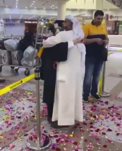 Kuwaiti father celebrating his daughters graduation after studying abroad.