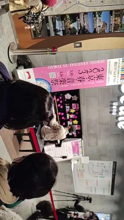 Kid playing at Ueno station in Tokyo