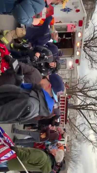 People freaking out as the woman shot at the Capitol building is loaded in Ambulance