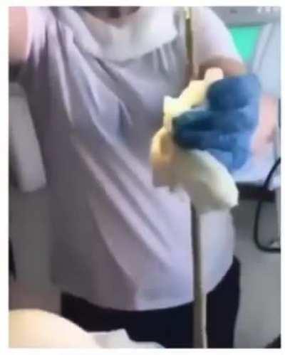 Removing this big work/parasite from this woman's body.