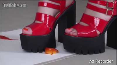 Diana with her platform sandals mercilessly crushing the fish.