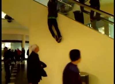 WCGW holding onto the side of an escalator