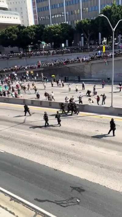 Riot police tackle guy on scooter