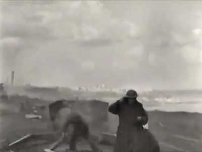 Canadian 17 pounder gunner fed up of adjusting his helmet after every shot near Ortona in Italy in late 1943