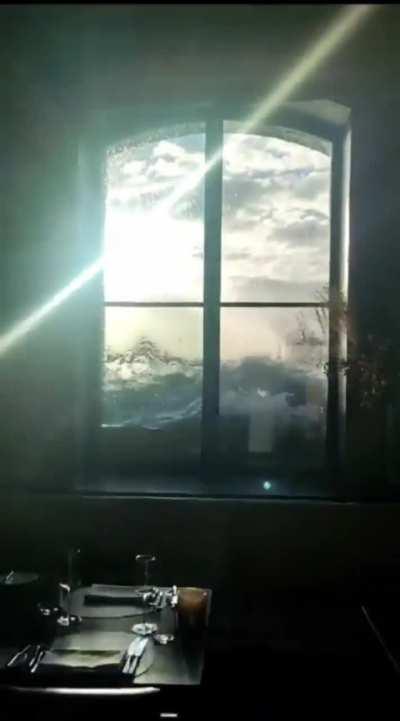 Window with view on the flooded harbour in Hamburg 
