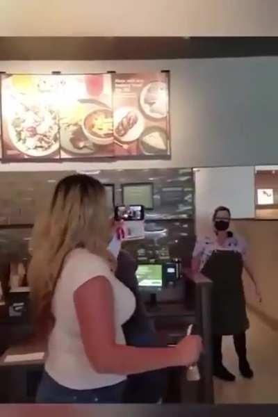 Karen doesn’t wear the mask that is in her hand