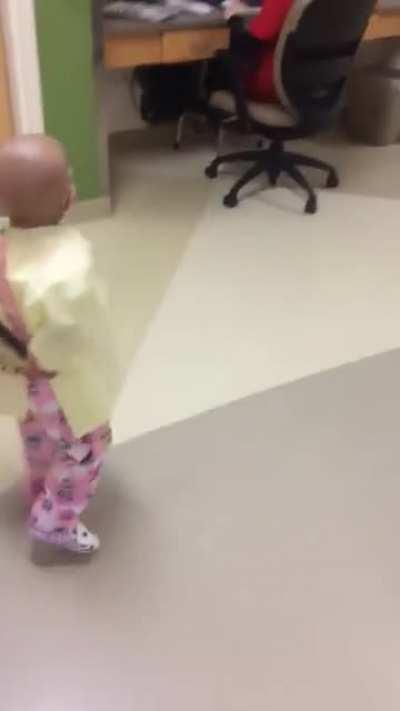 A cancer patient scares a nurse with a toy.