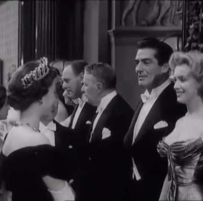 In this rare footage from October 29, 1956, Queen Elizabeth II greets Marilyn Monroe at a film premiere. The two met at the premiere of The Battle of the River Plate in London's Leicester Square.
