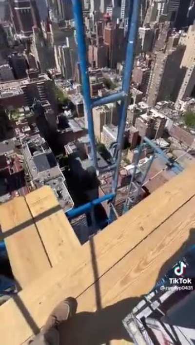 These NYC Construction Workers skillfully traverse the scaffolding