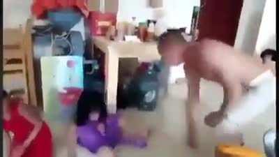 Chinese man beating up 3 young Uyghur girls who are forced to live with him by the government in attempt to become more 