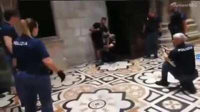 Italian police acting on a hostage in a church.