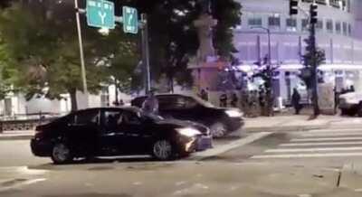 This man isn't a protester. He was just a guy sitting at a traffic light when cops shot his car with a tear gas round. He got out to yell at them because his pregnant wife is in the vehicle. So they opened fire on them.