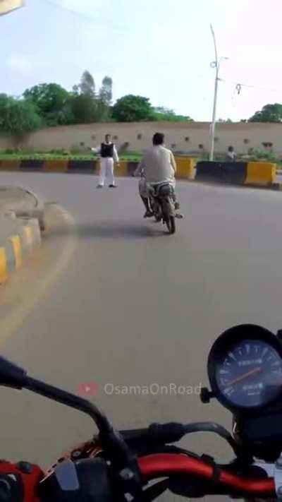 Biker riding with no helmet or indicators or lane discipline or common sense didn't expect what was around the corner