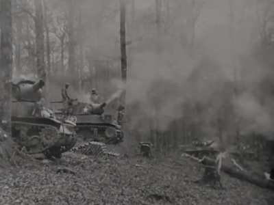 Howitzer Motor Carriage M8 battery in action firing from a wooded area circa late 1944