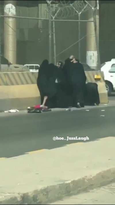 Mothers in Sudan fighting in the street with their babies in their arms 