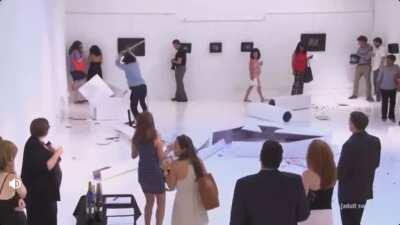 Eric Andre causing mass chaos in an art gallery.