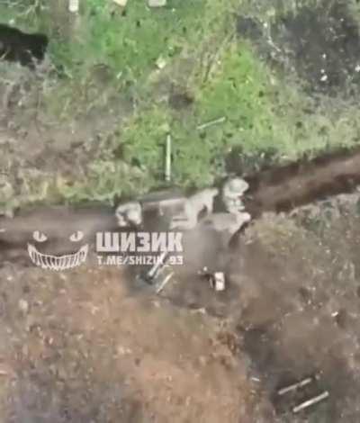 Ukrainian drone films fragmentation grenade drop on an occupied Russian trench position, claimed to be in the Bakhmut direction. NSFW