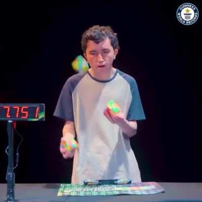 Colombian Angel Alvarado solves three Rubik’s Cubes while juggling them