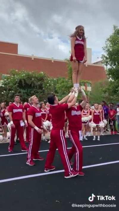 Oklahoma Sooner cheerleader does a stunt