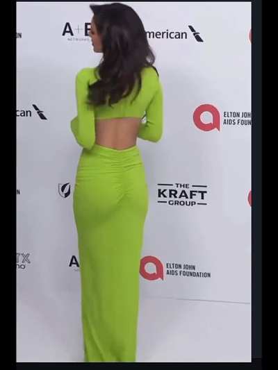 Victoria in green on red carpet.