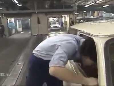 Quality control and end of line repairs at the Trabant factory. With kicks, hammer and mullet.
