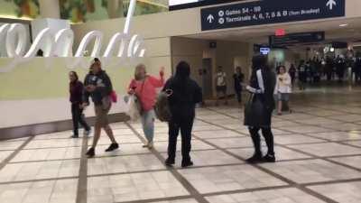 Woman in airport screams for help because she claims her headphones were stolen…