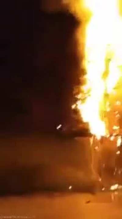 putting a Christmas tree next to a giant spark machine