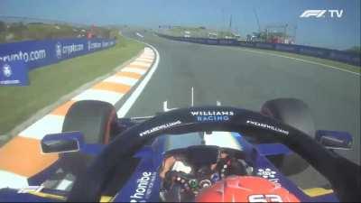 George Russell clips the grass while working on his steering wheel