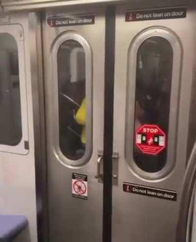 A couple having sex in between two train cars.