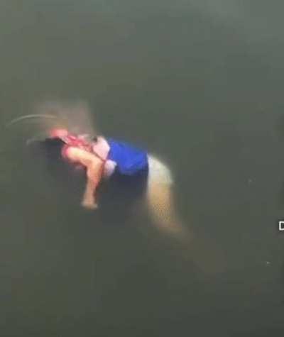 A woman falls victim to the jaws of a Crocodile.