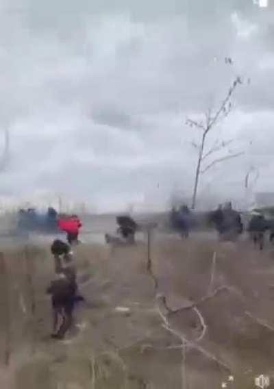 Russians shooting civilians. Man loses his leg.